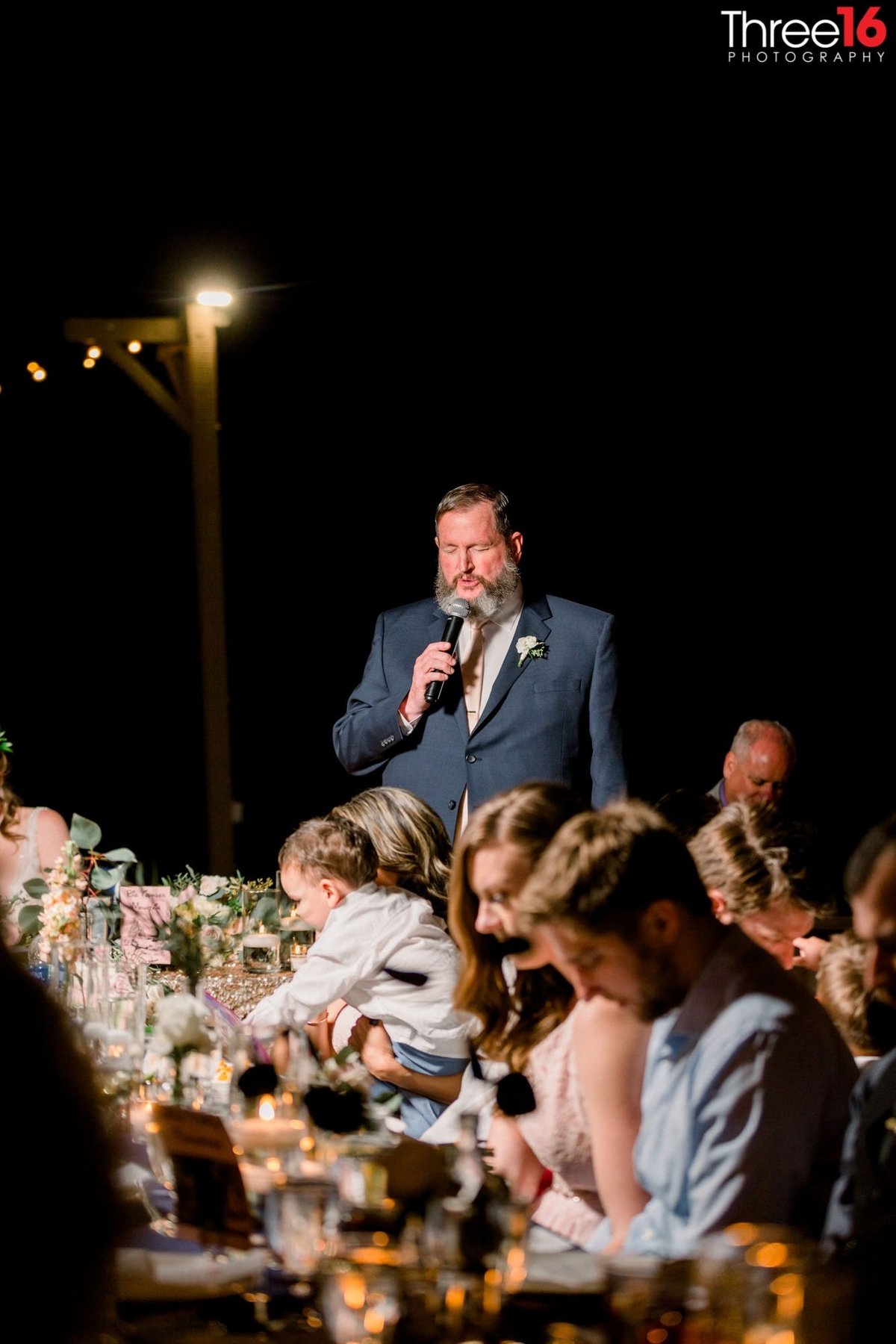 Dinner Prayer being said at a wedding reception