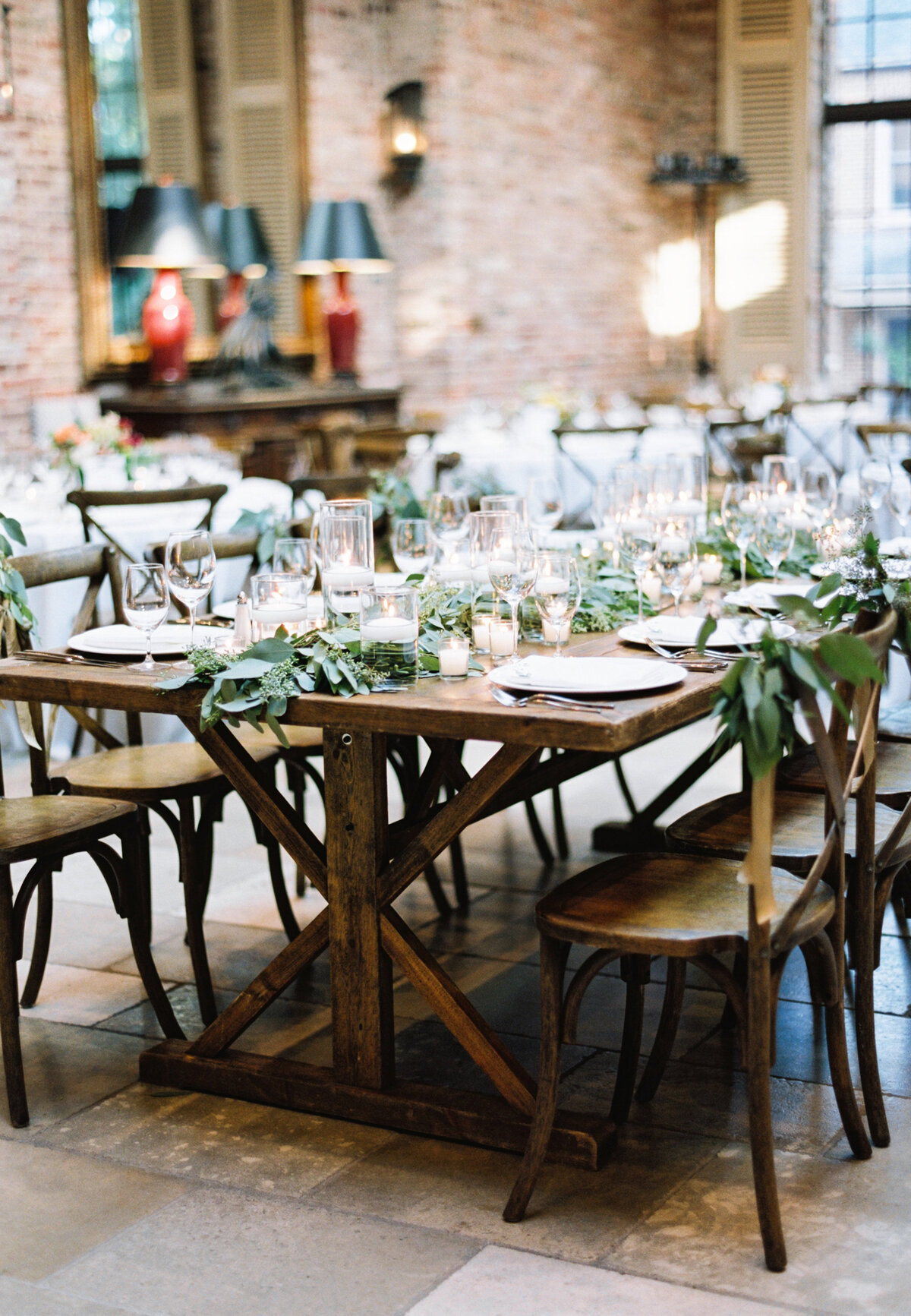 Wedding tablescape with white candles and greenery