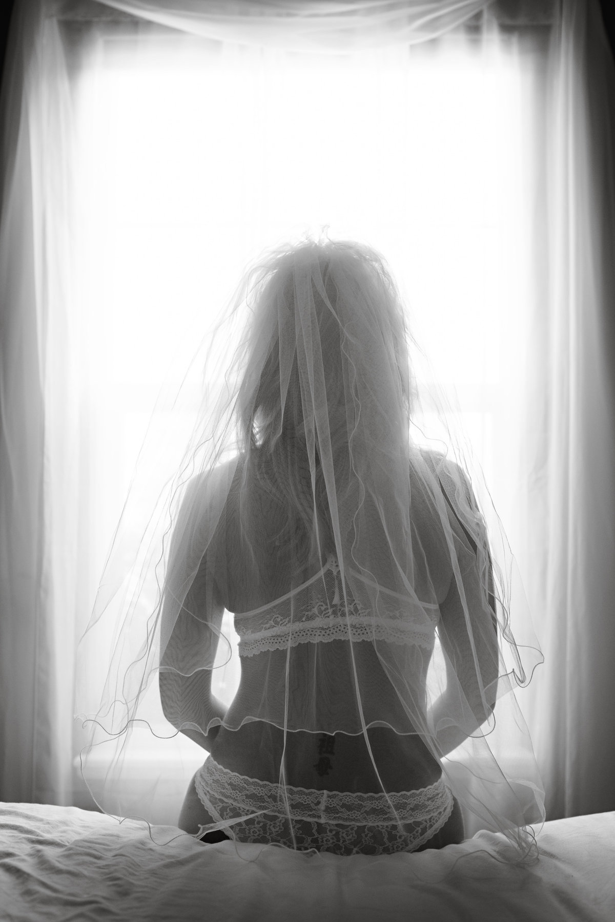 Sexy bride to be in her veil from the back