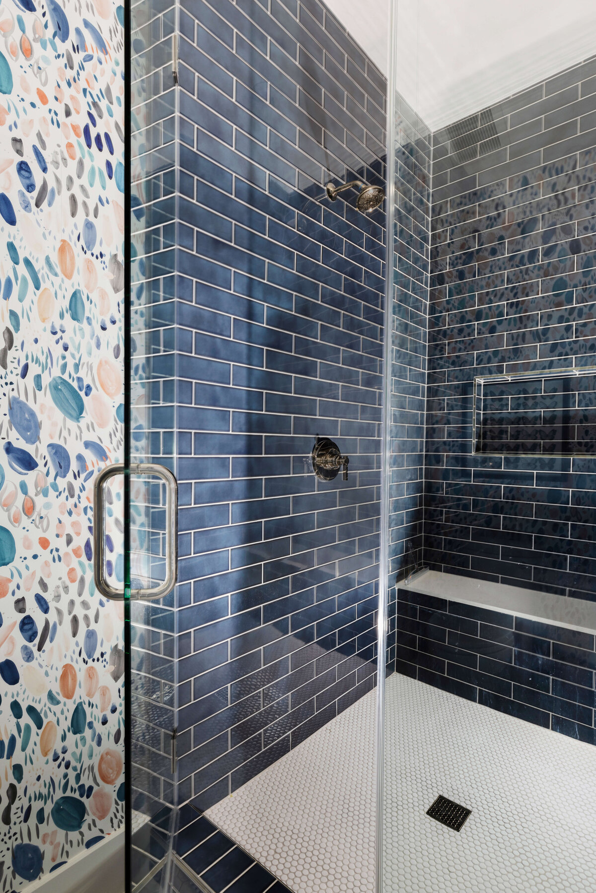 oyster creek studios missouri city new build dark blue tiled shower and watercolor pattern wallpaper in bathroom