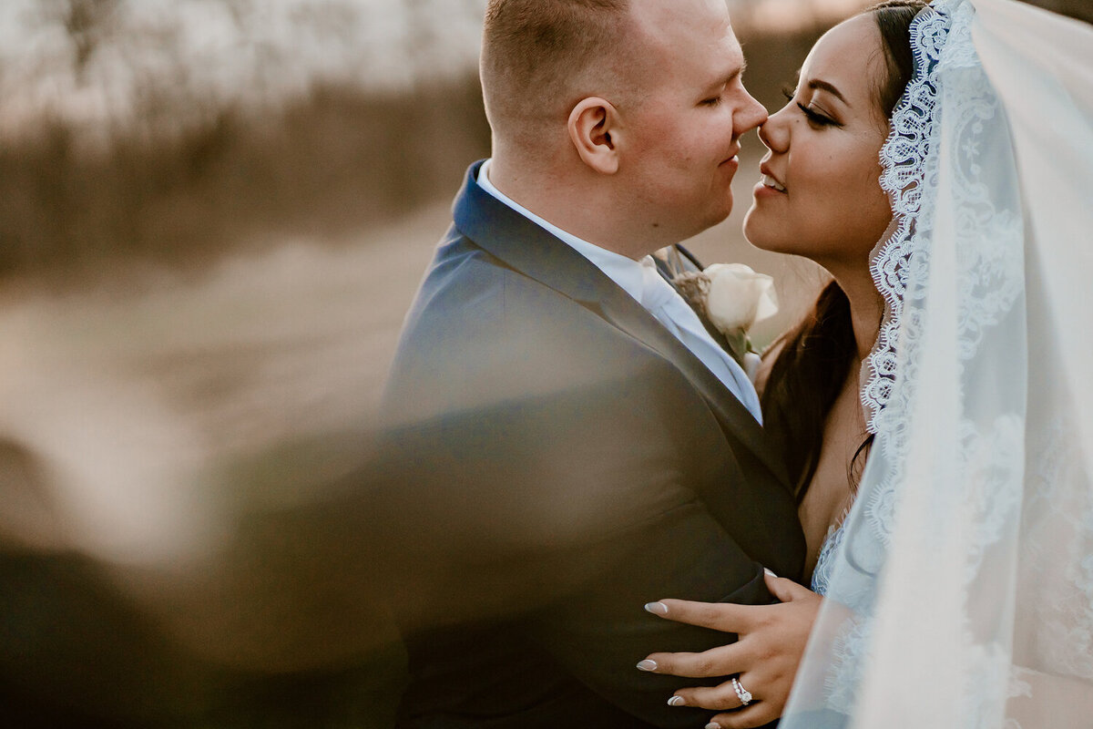 intimate-sunset-embrace-couple-veil-ashton-hill-farm-cedar-rapids-iowa-storyteller-collective-photo-co
