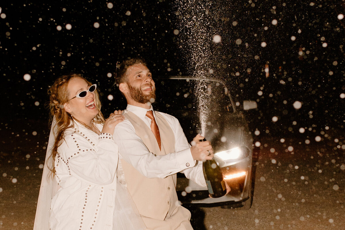 Splashing champagne on elopement day