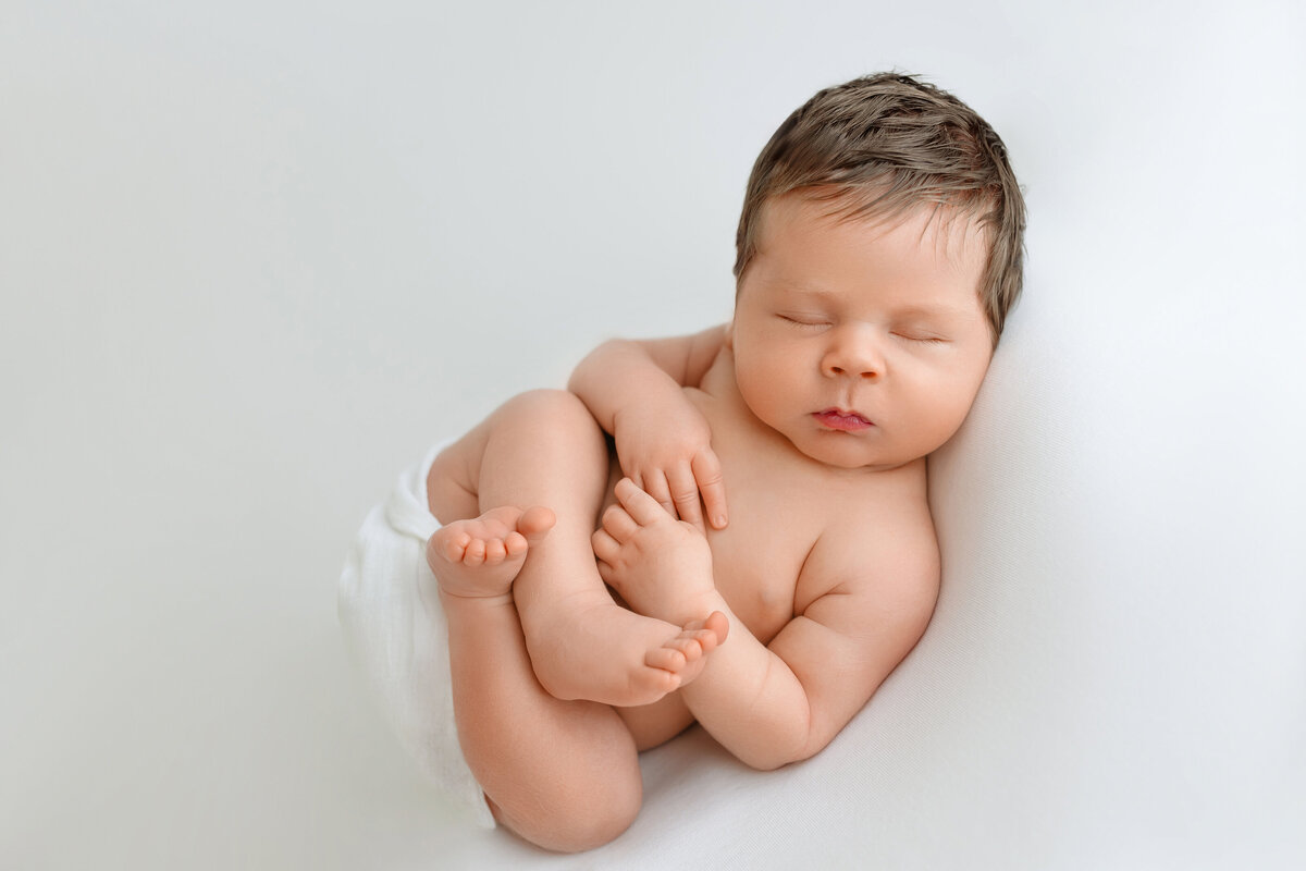 newborn in huck fin pose