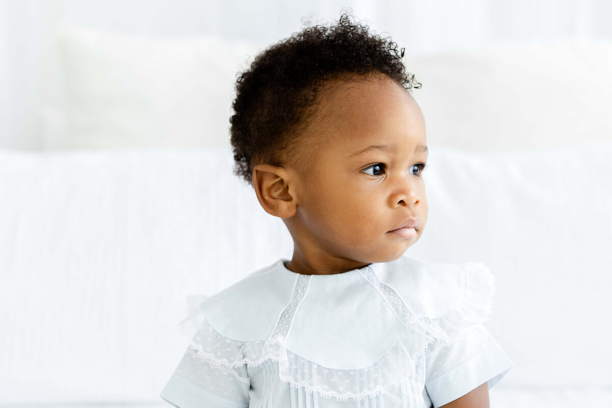 Baby looking off camera with serious face for milestone photography