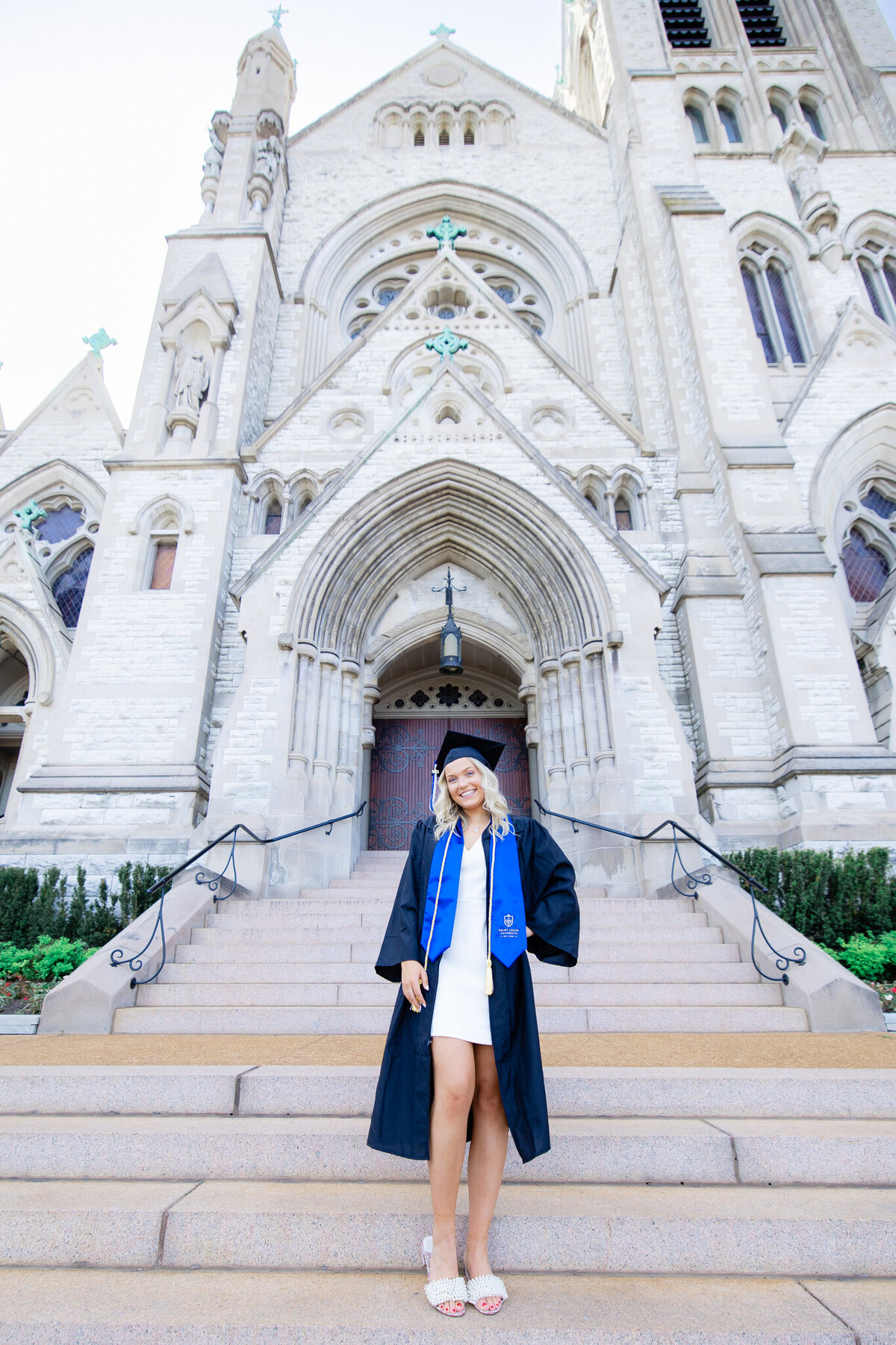 senior girl at SLU in front of Francis Xavier church on the stairs