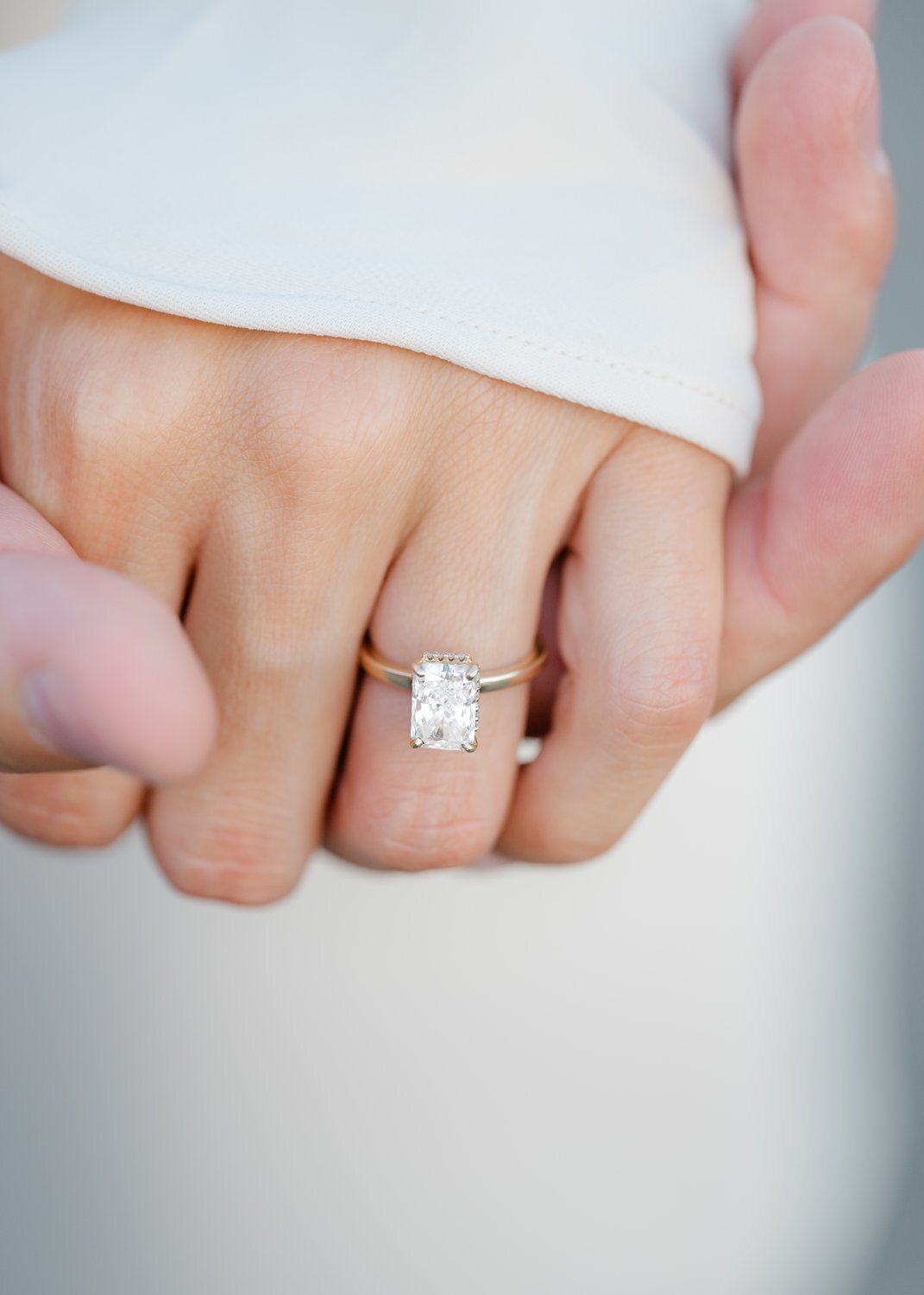 detail photo of engagement ring on woman's hand