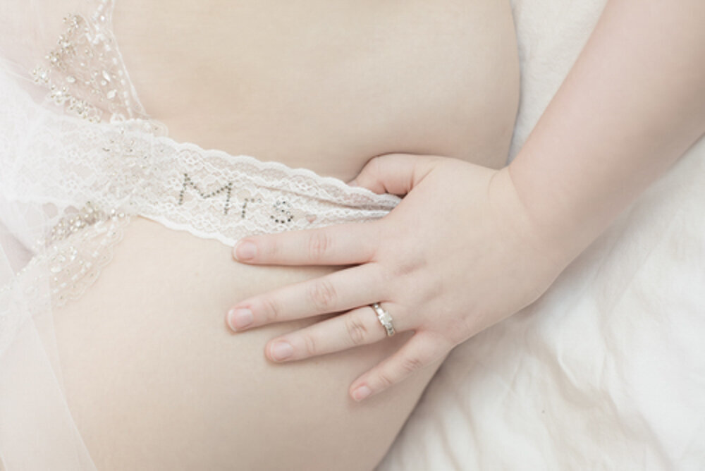 Bride to be in Mrs Underwear showing engagement ring