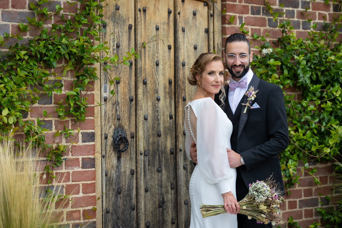 A bride and groom stand outside after their Italian wedding ceremony.
