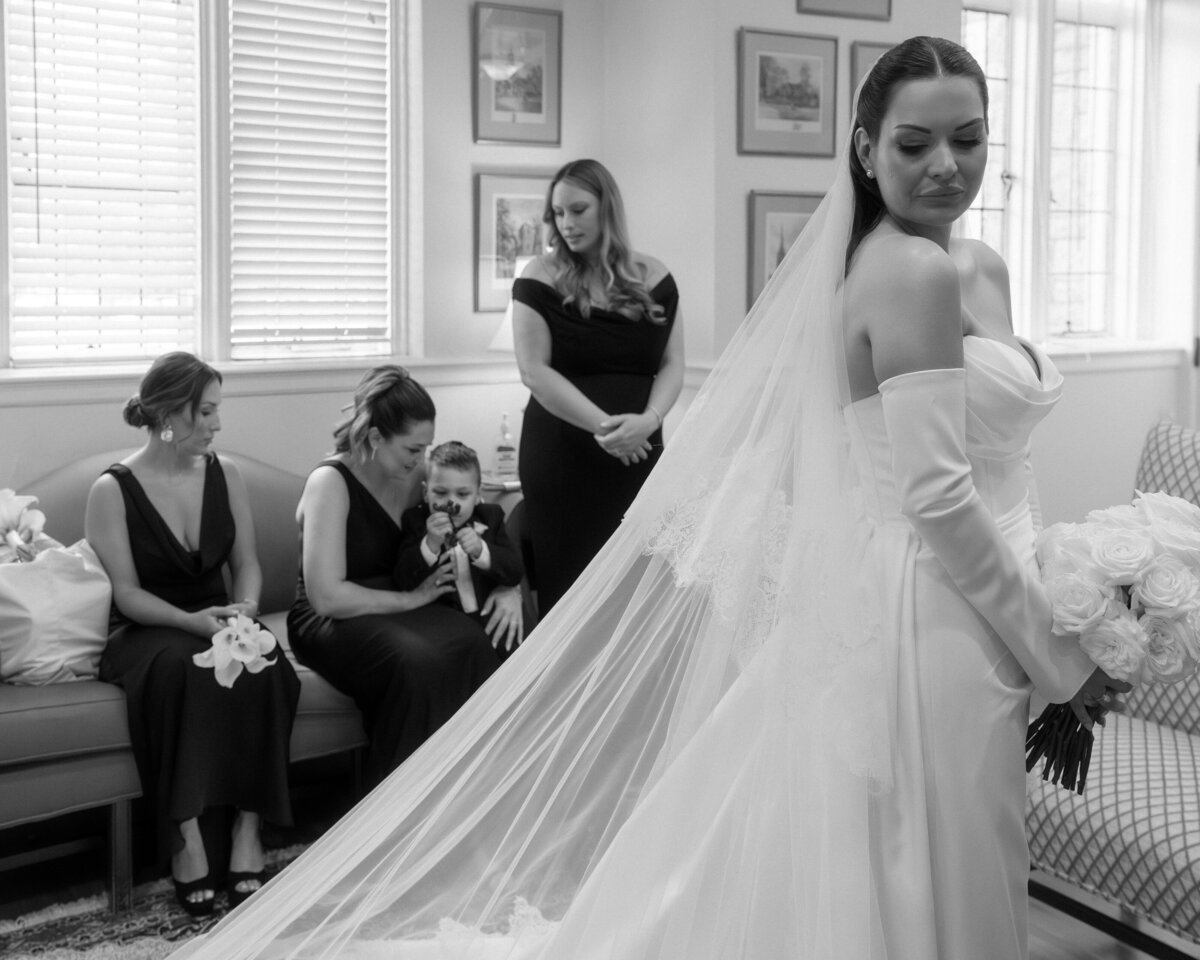 bride-posing-getting-ready-suite-pre-ceremony-with-bridesmaids