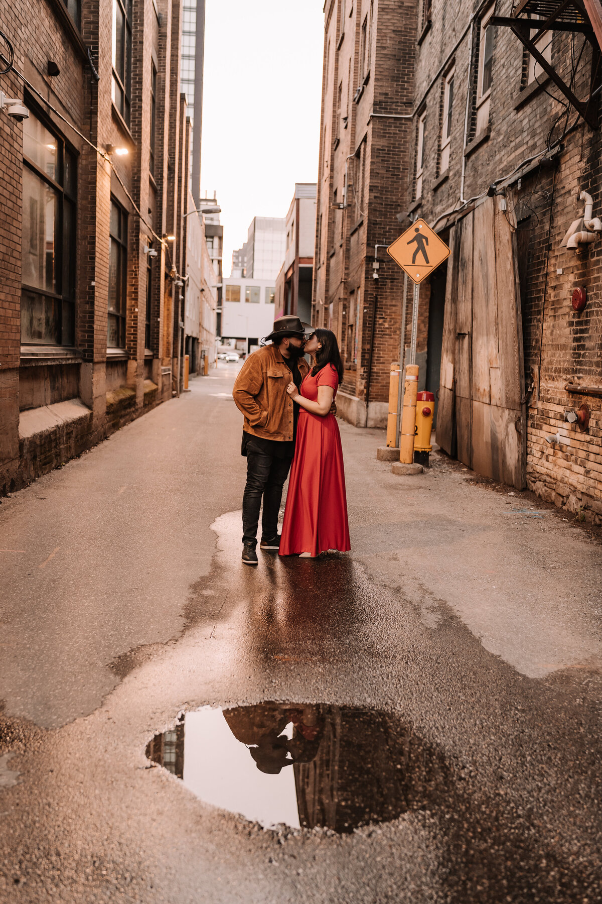 Couple embracing in alley downtown kitchener