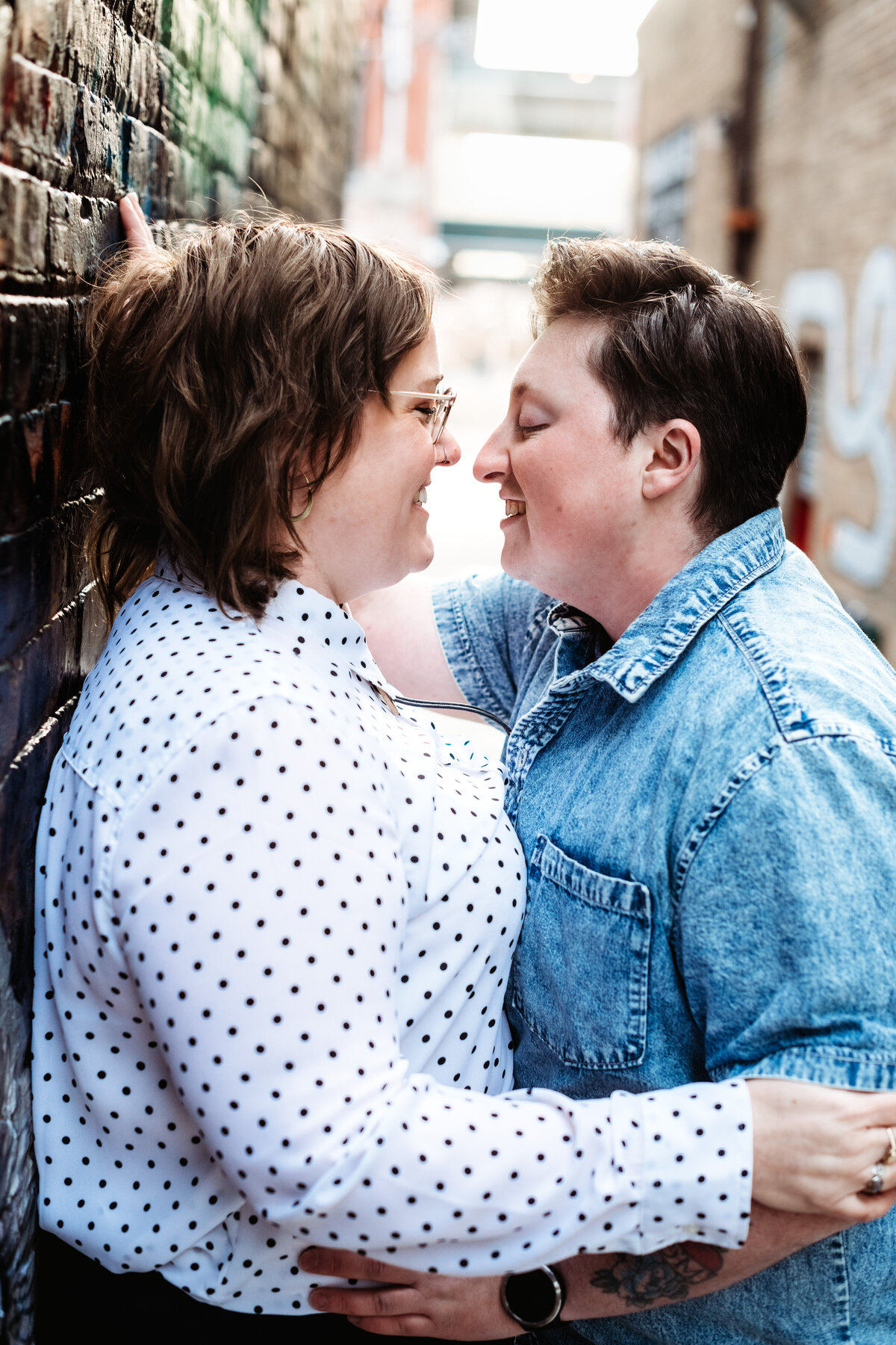 LGBTQIA+ couple smiling at each other