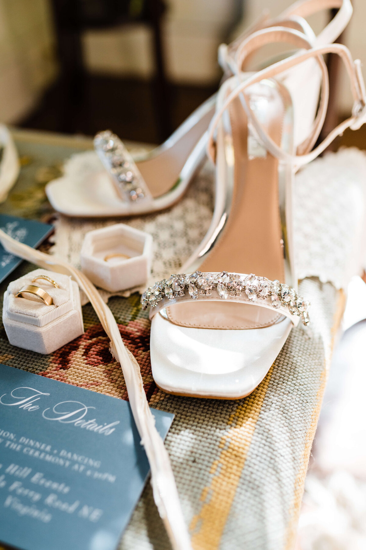 detail shot of wedding heels that are white with crystals on the strap