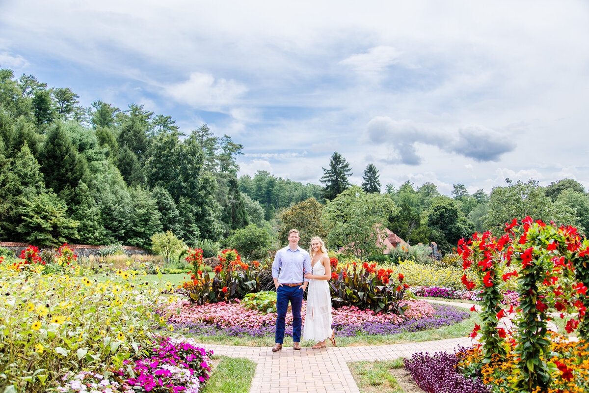 couple standing in the middle of flower garden at Biltmore Flower Gardens