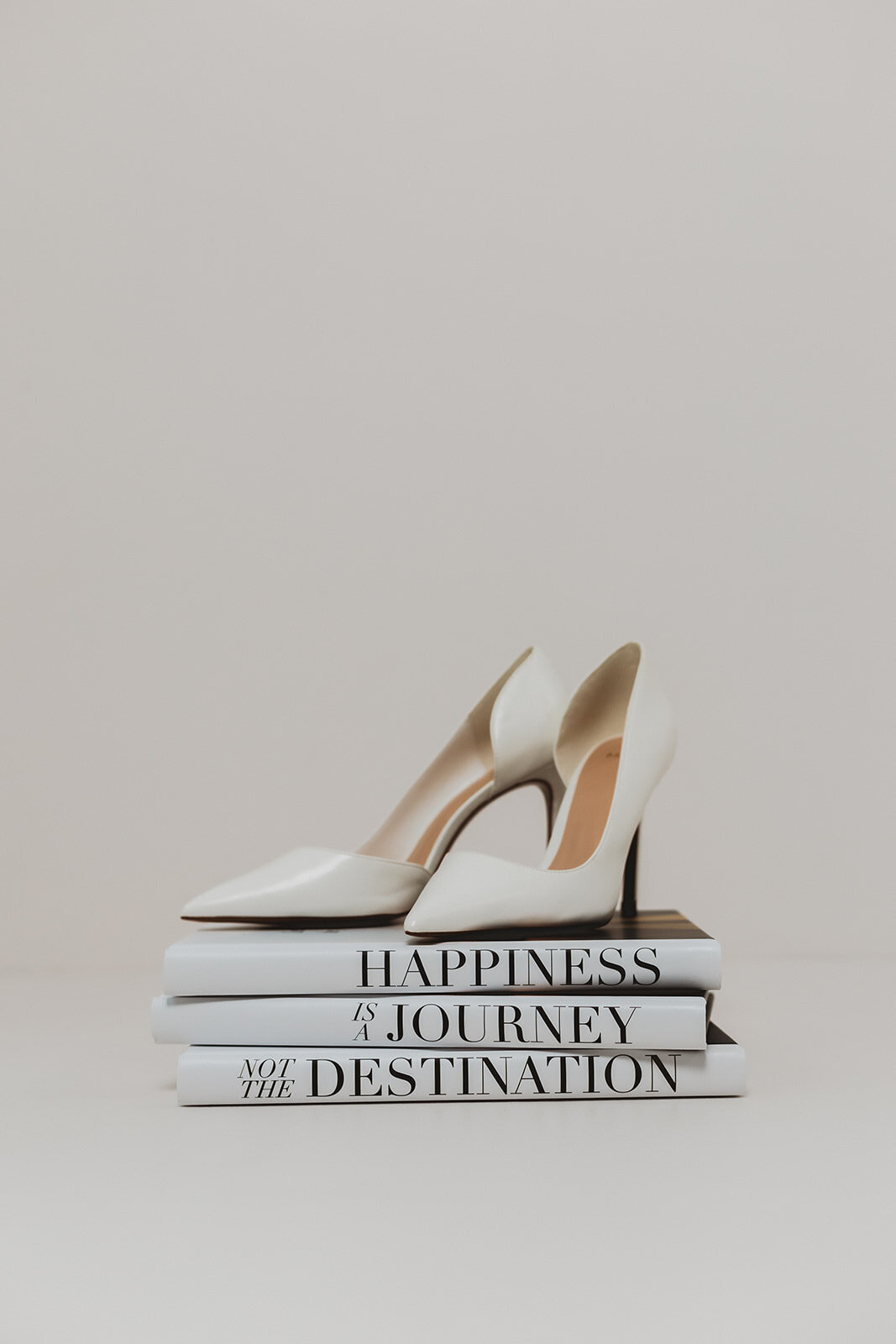 white pumps on a stack of books