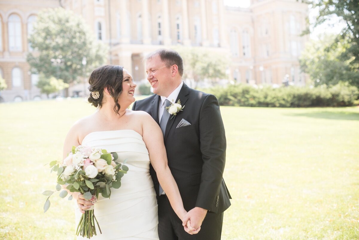 a bride and groom holding hands on their wedding day