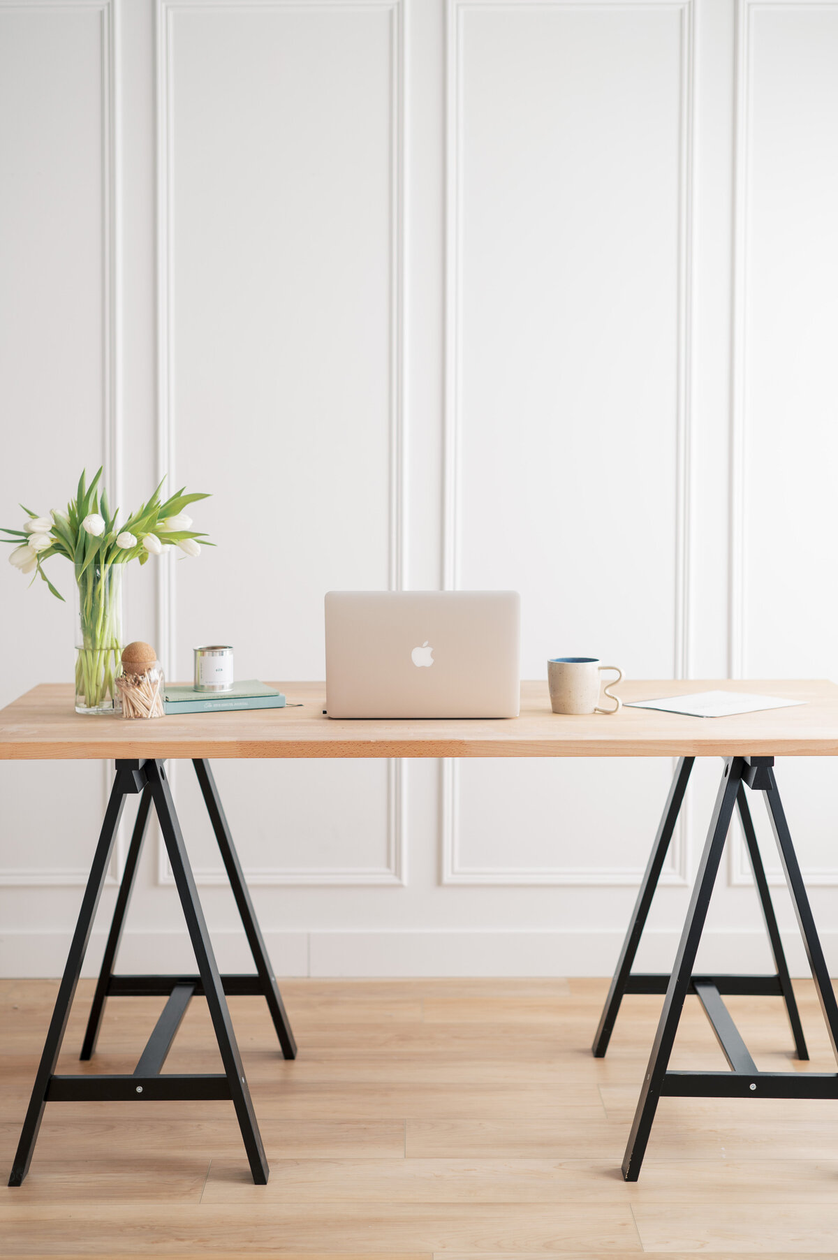 Brand photography of a graphic designer desk set up with minimal white wall