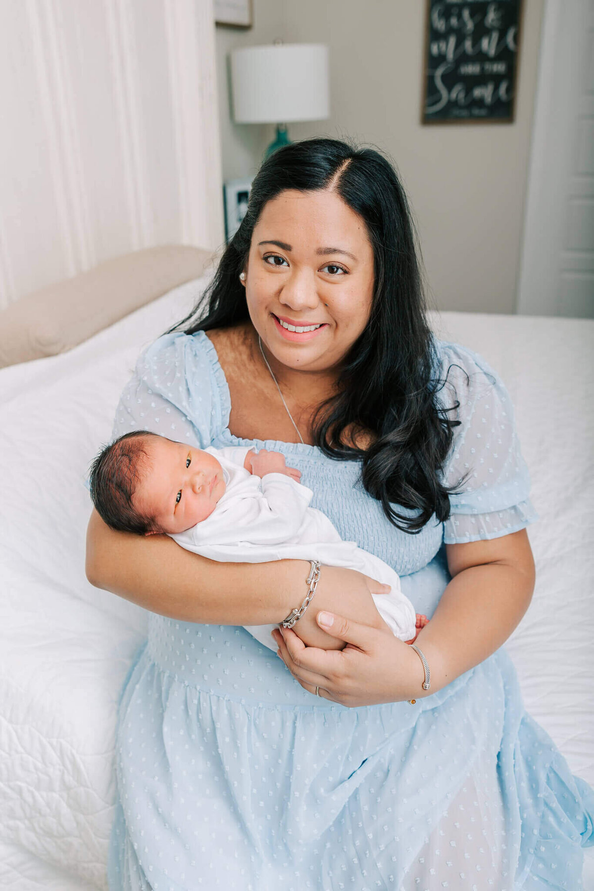 New mom holding her baby boy during their in-home newborn session in Aiken, South Carolina