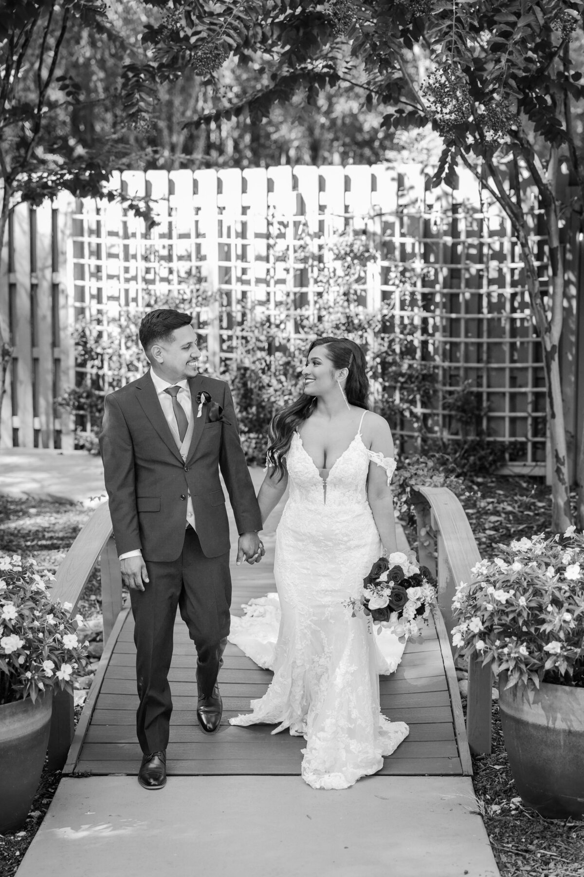Bride & Groom walk through the garden at Venue 92, Woodstock GA