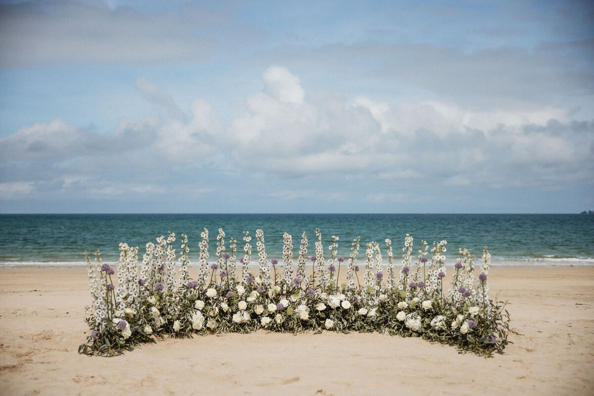 Semi crescent ceremony flowers on the beach at Carbis Bay