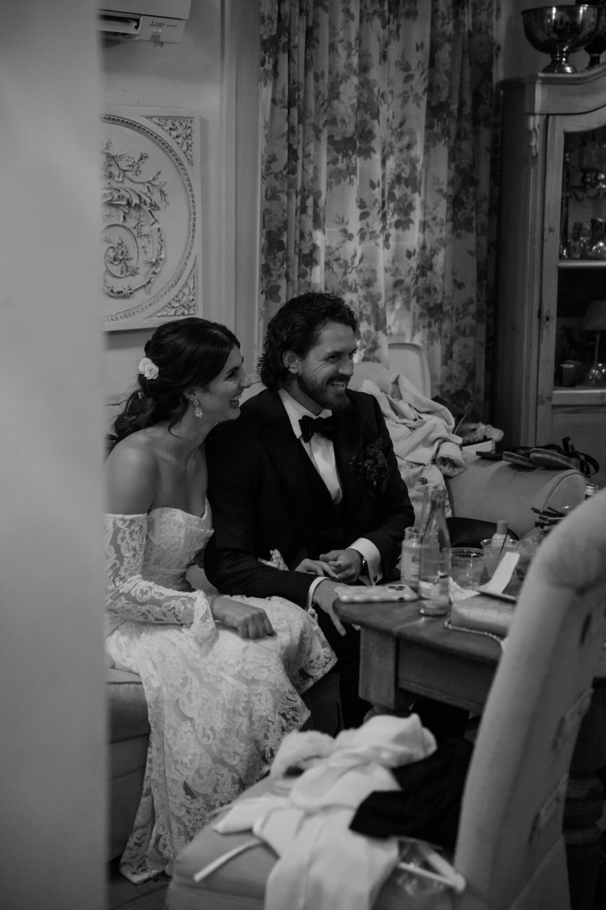bride and groom during reception laughing and talking 