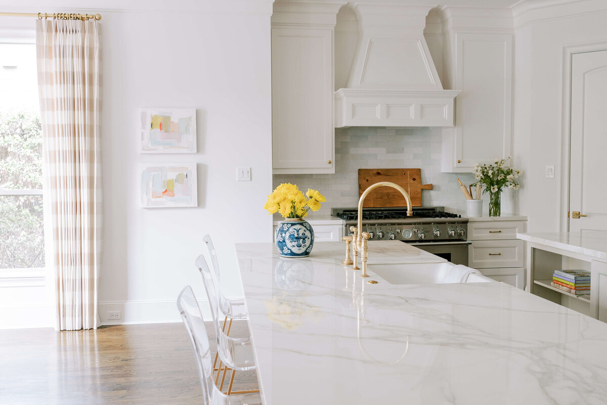 oyster creek studios hause white kitchen with gold hardware and marble countertops