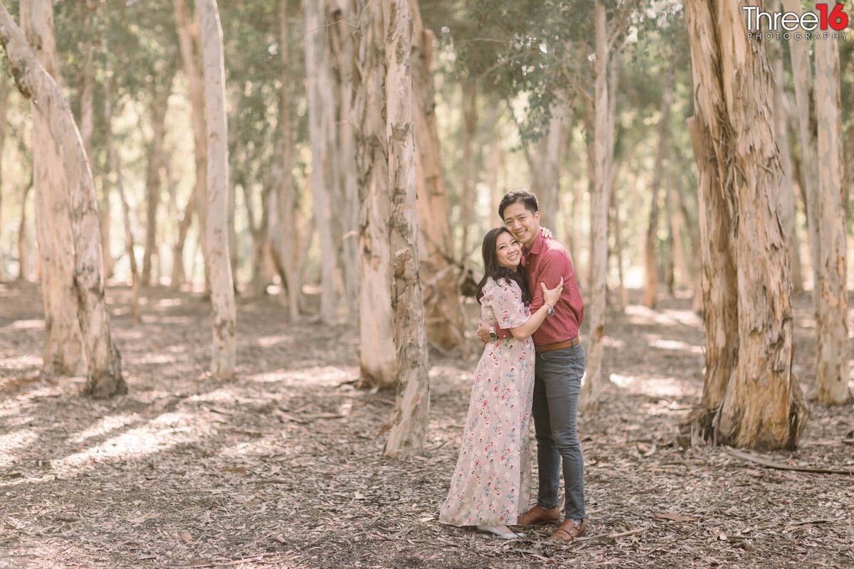 Tener embrace by engaged couple during engagement shoot in Lake Forest, CA