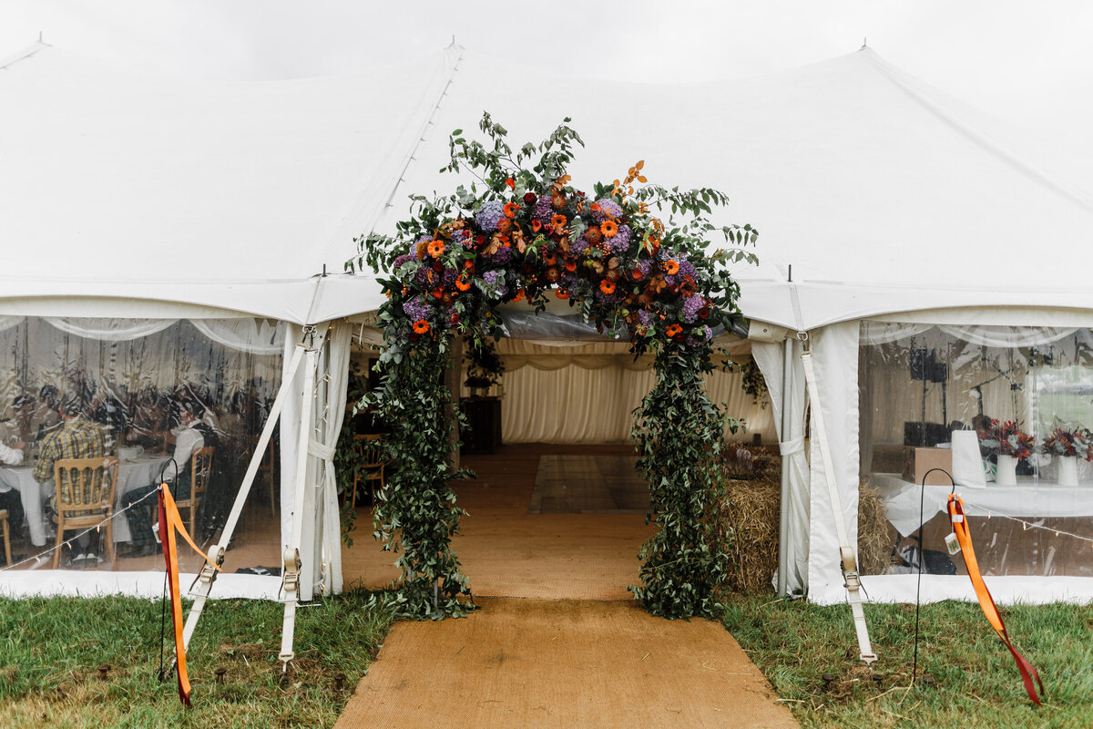 Arch of flowers for the entrance to this marquee