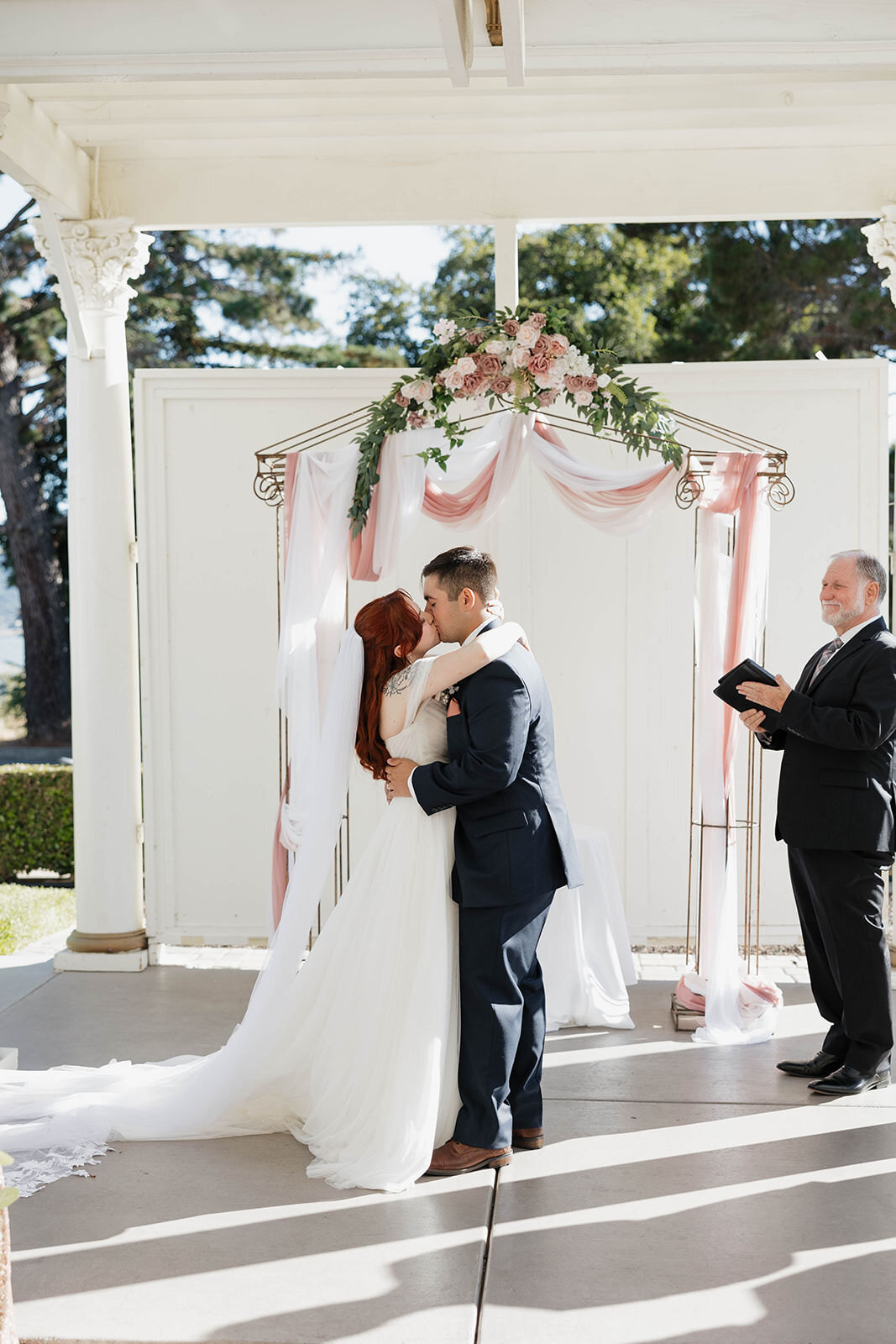 Ceremony under a white arch