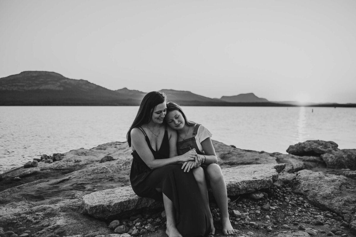 mother-and-daughter-sitting-in-front-of-lake