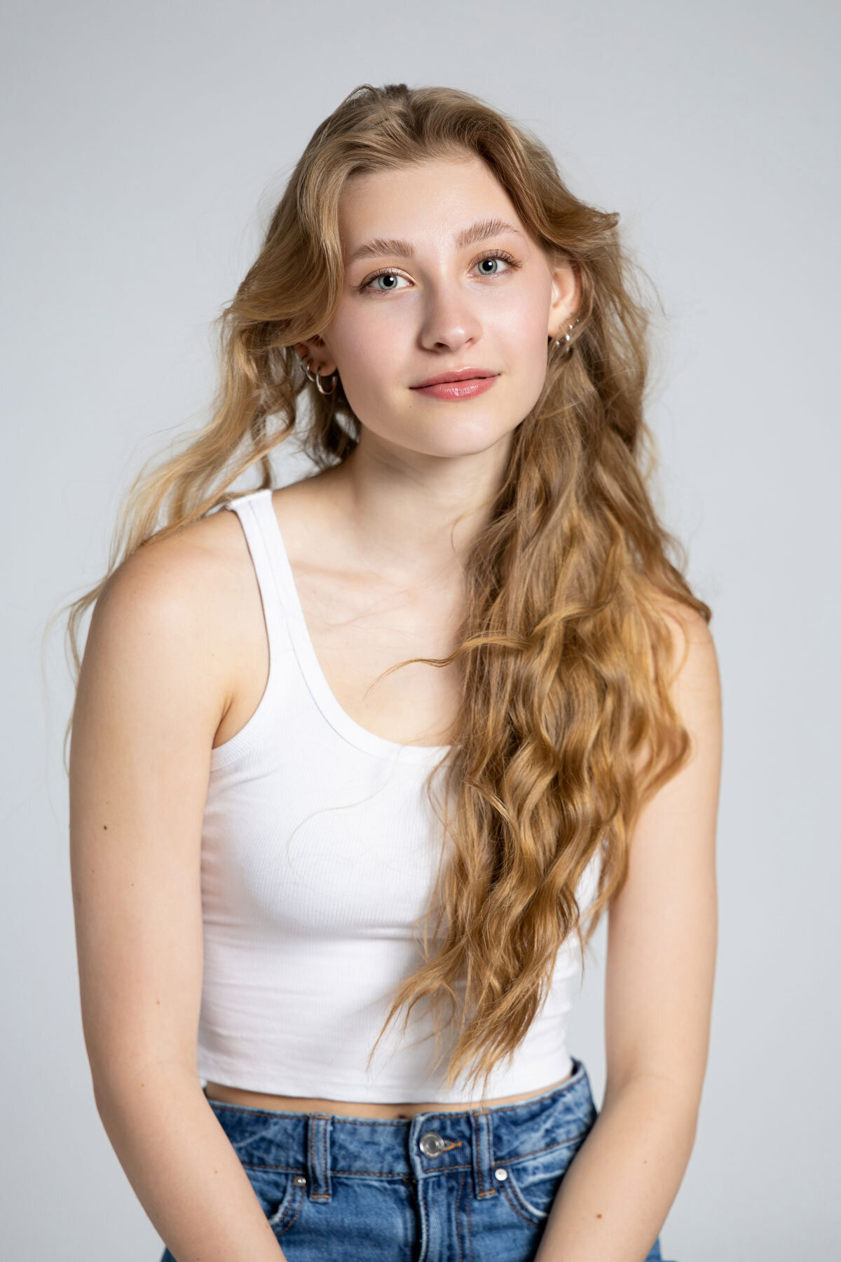 Senior picture of girl taken on white background in Utah studio.