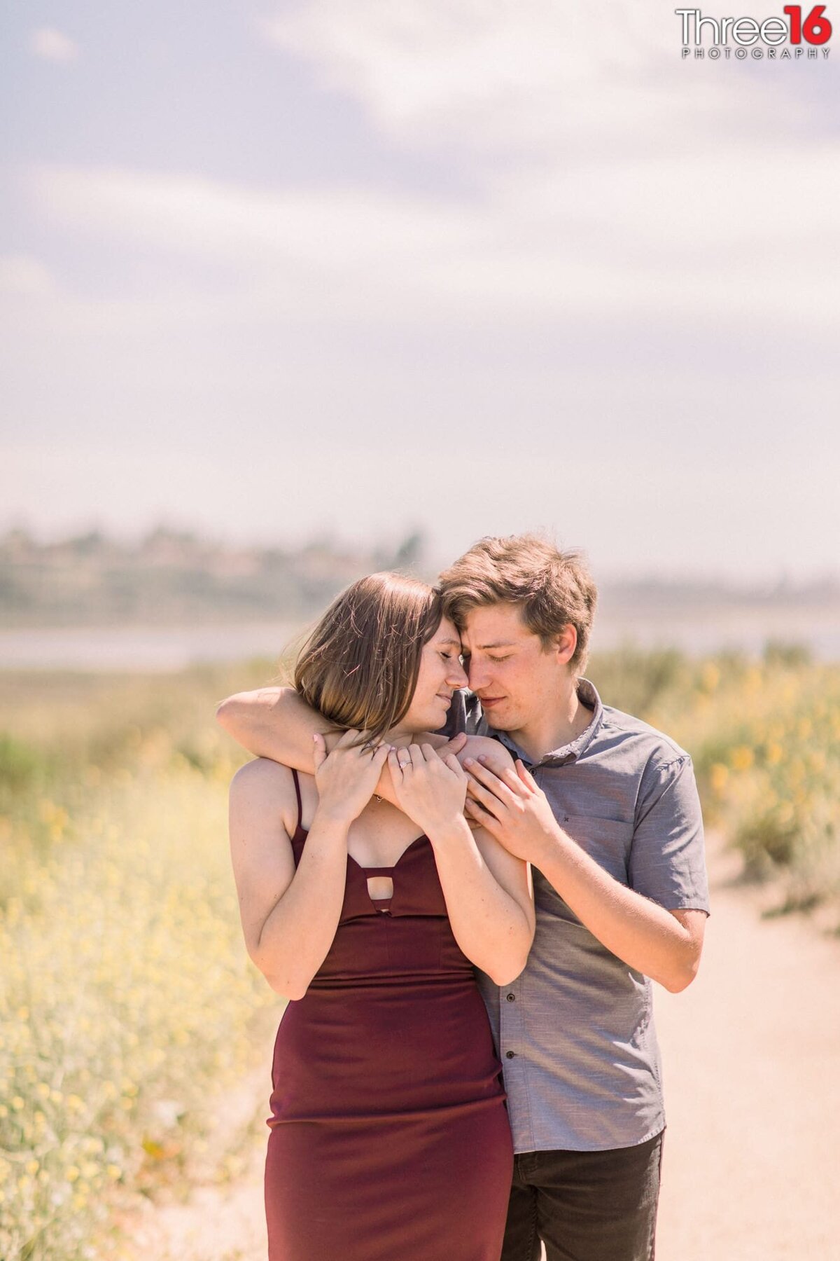 Tender moment for engaged couple during their Upper Newport Bay Nature Preserve engagement photo session