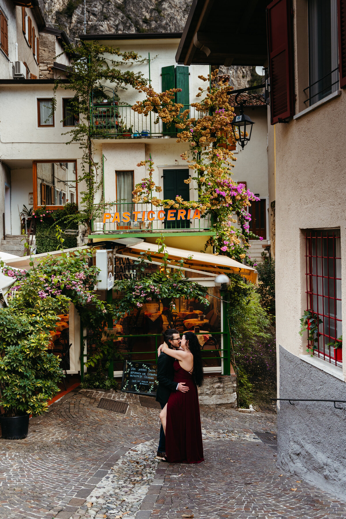 Couple walking playfully through Limone sul Garda streets