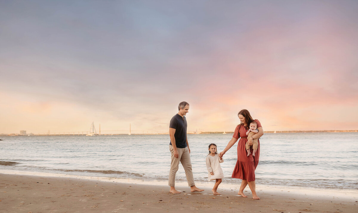 Family walks along the beach together during Beach Family Photos in Charleston.