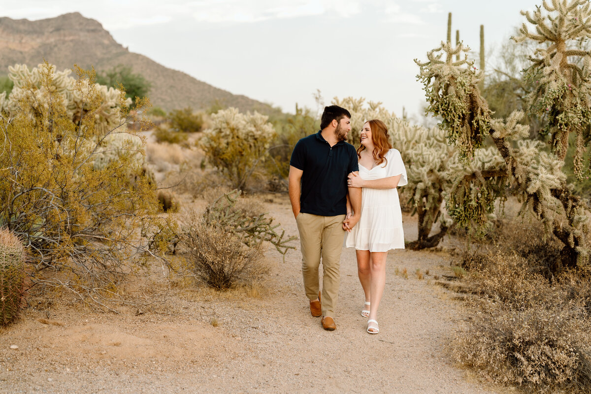 Man and woman walking holding hands