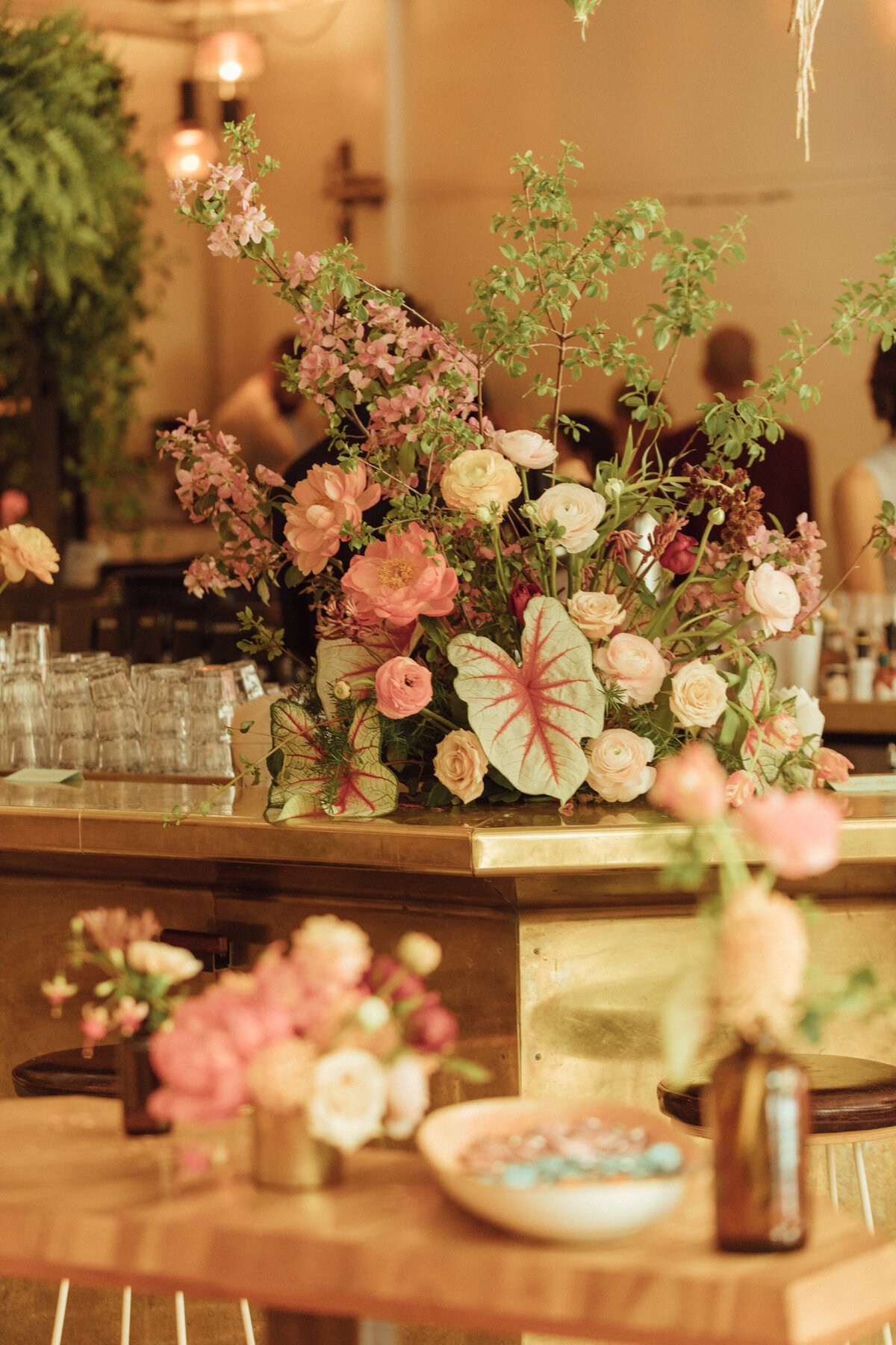 A marble countertop at Bar Furco is topped with a bright garden arrangement at a Montreal wedding.