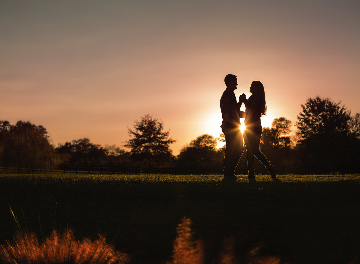 Couple pose at sunset during an engagement session in Charlotte NC