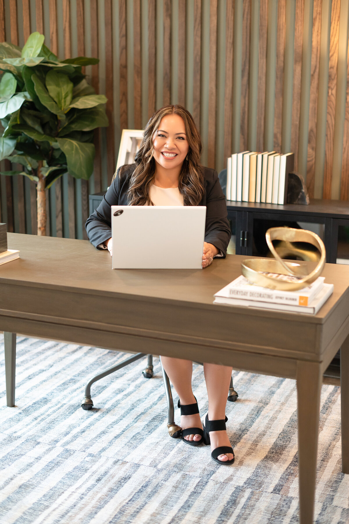 Smiling businesswoman at laptop during Houston personal branding session