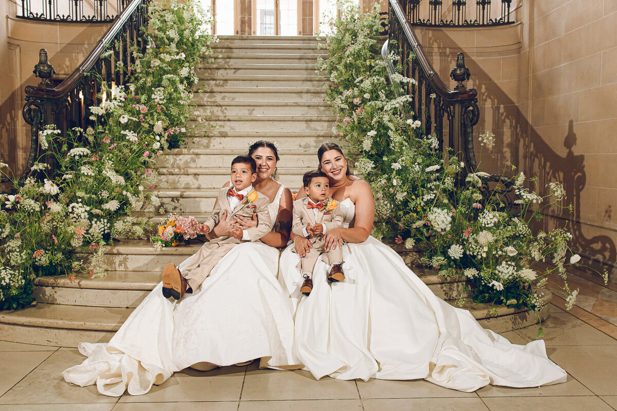 A couple poses with their ring bearers at Armour House in Lake Forest