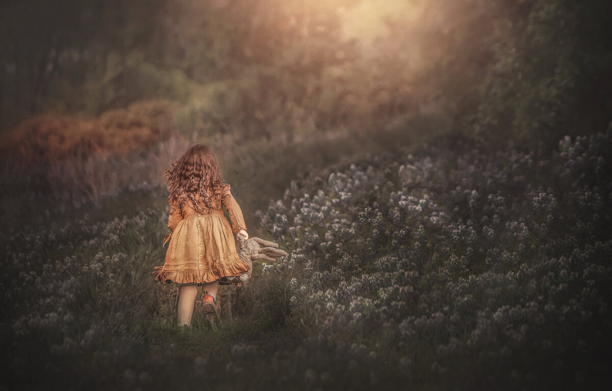 girl running in a flower field in an outdoor photography session in Ottawa Ontario