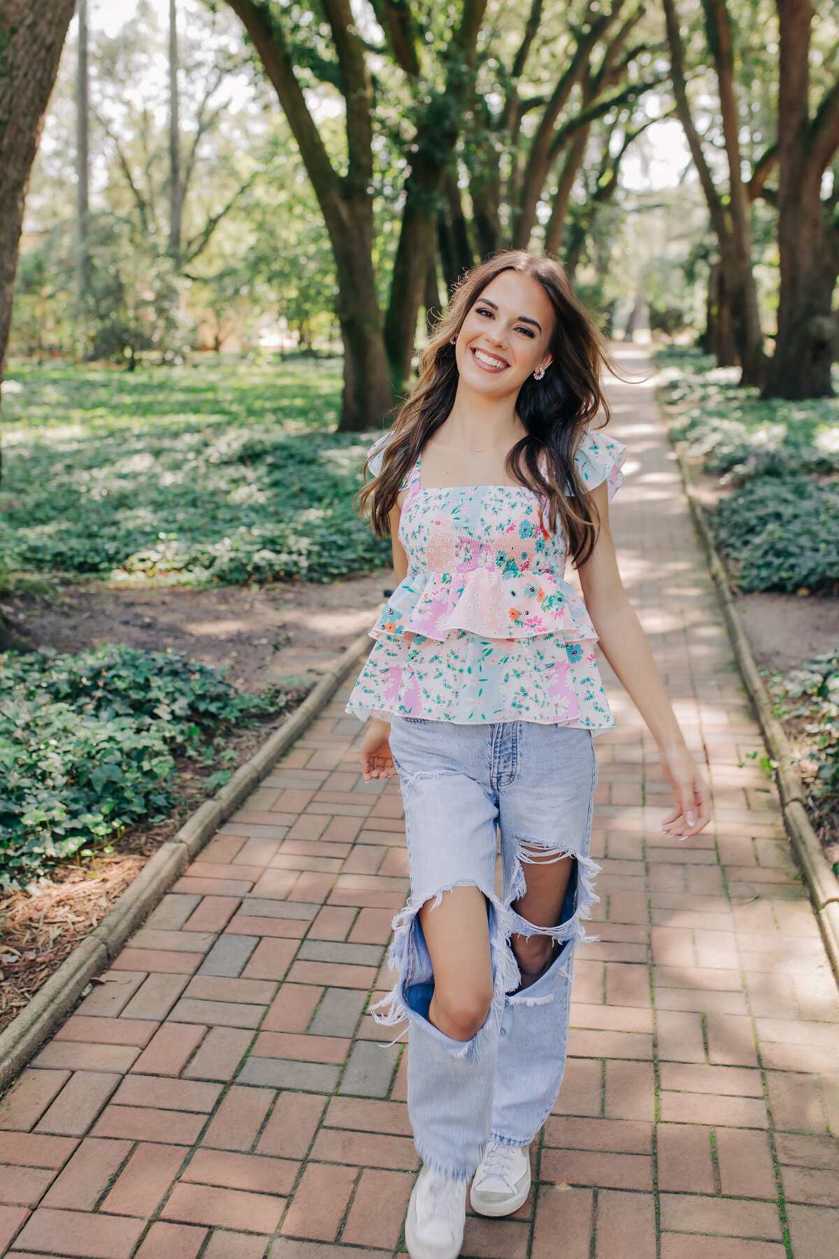 Smiling high school senior girl posing outdoors during golden hour in Augusta, GA.