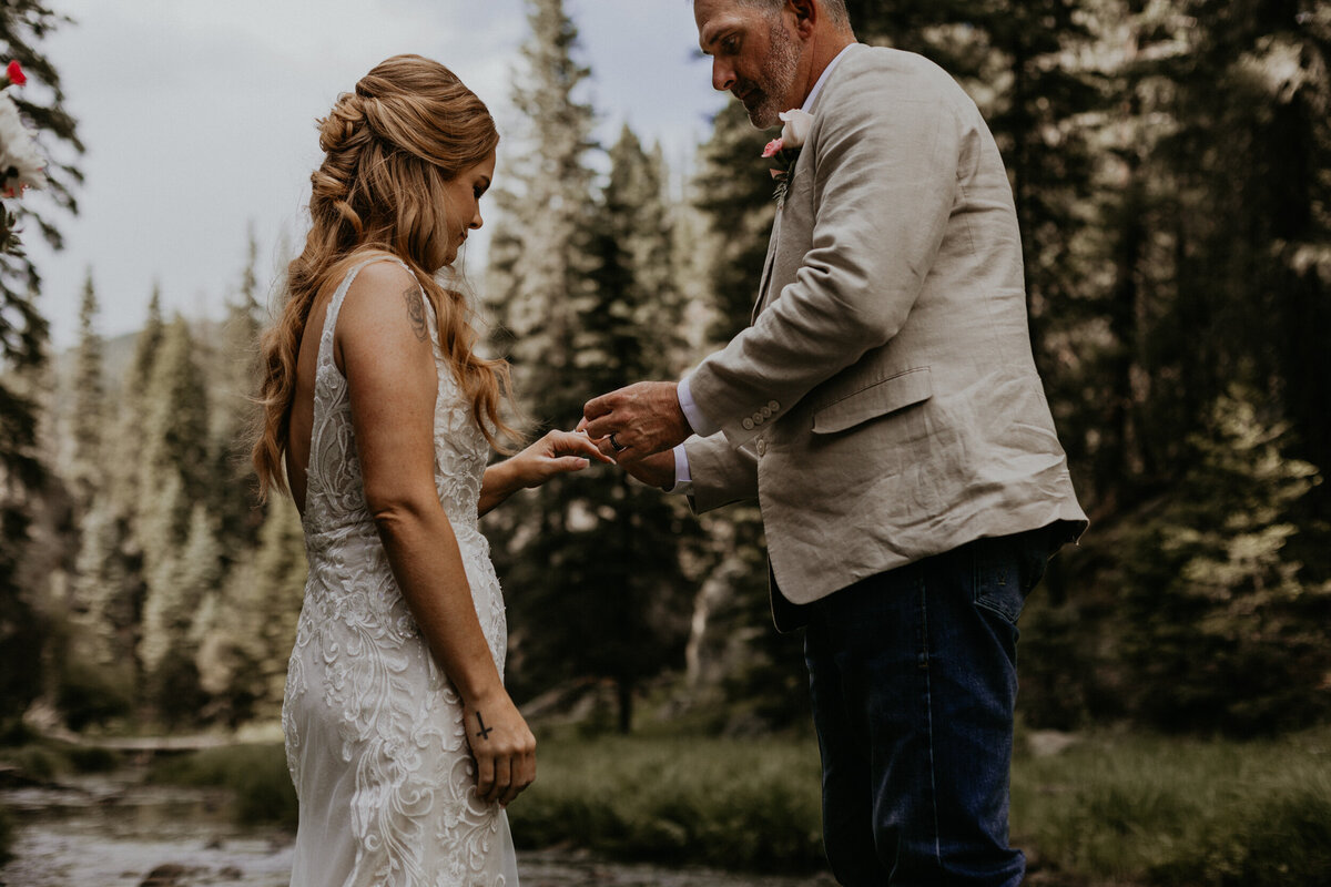 bride and groom exchanging rings during their wedding ceremony