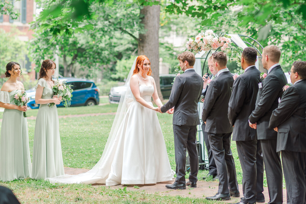 bride and groom during ceremony on sunny day in Gratz Park