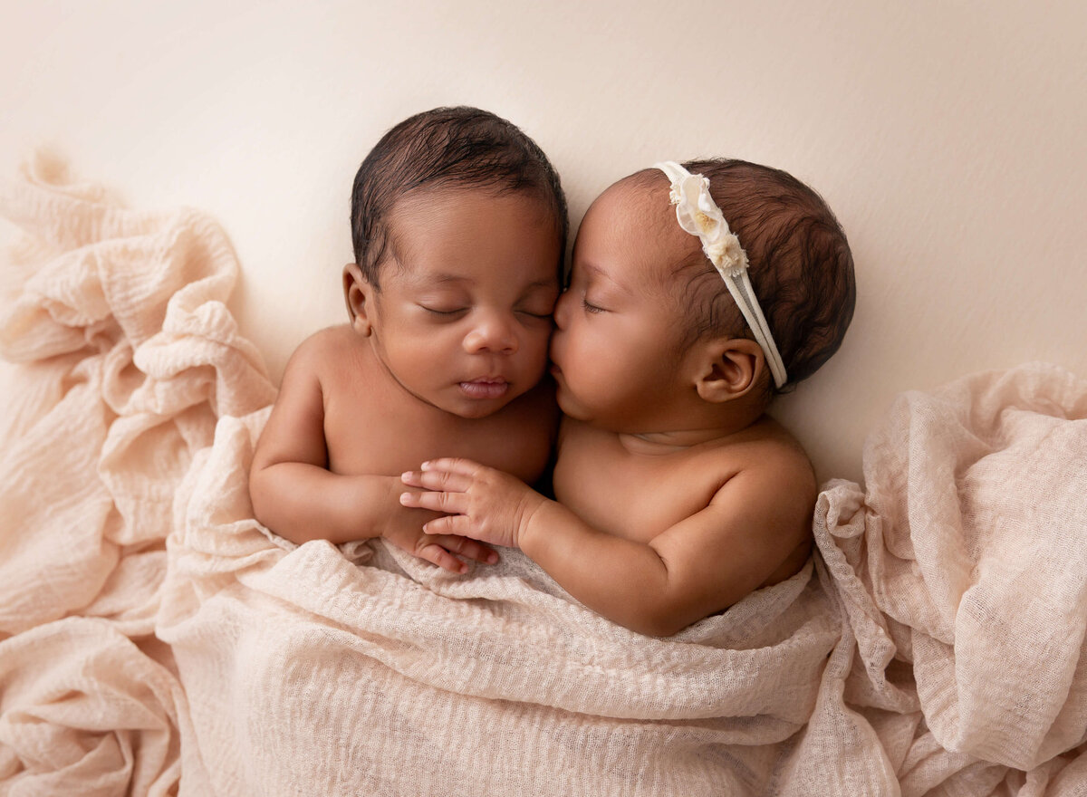 Twins Newborn pictures baby girl kissing her brother Timeless portraits captured by NYC newborn photographer 