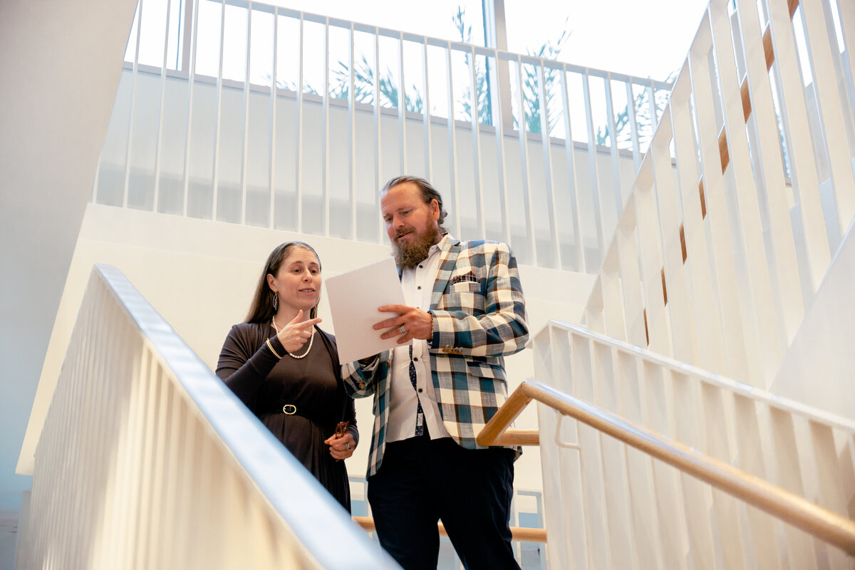 Jarrett and Rebecca, Co-Founders of NKB Consultancy talking on the stairs