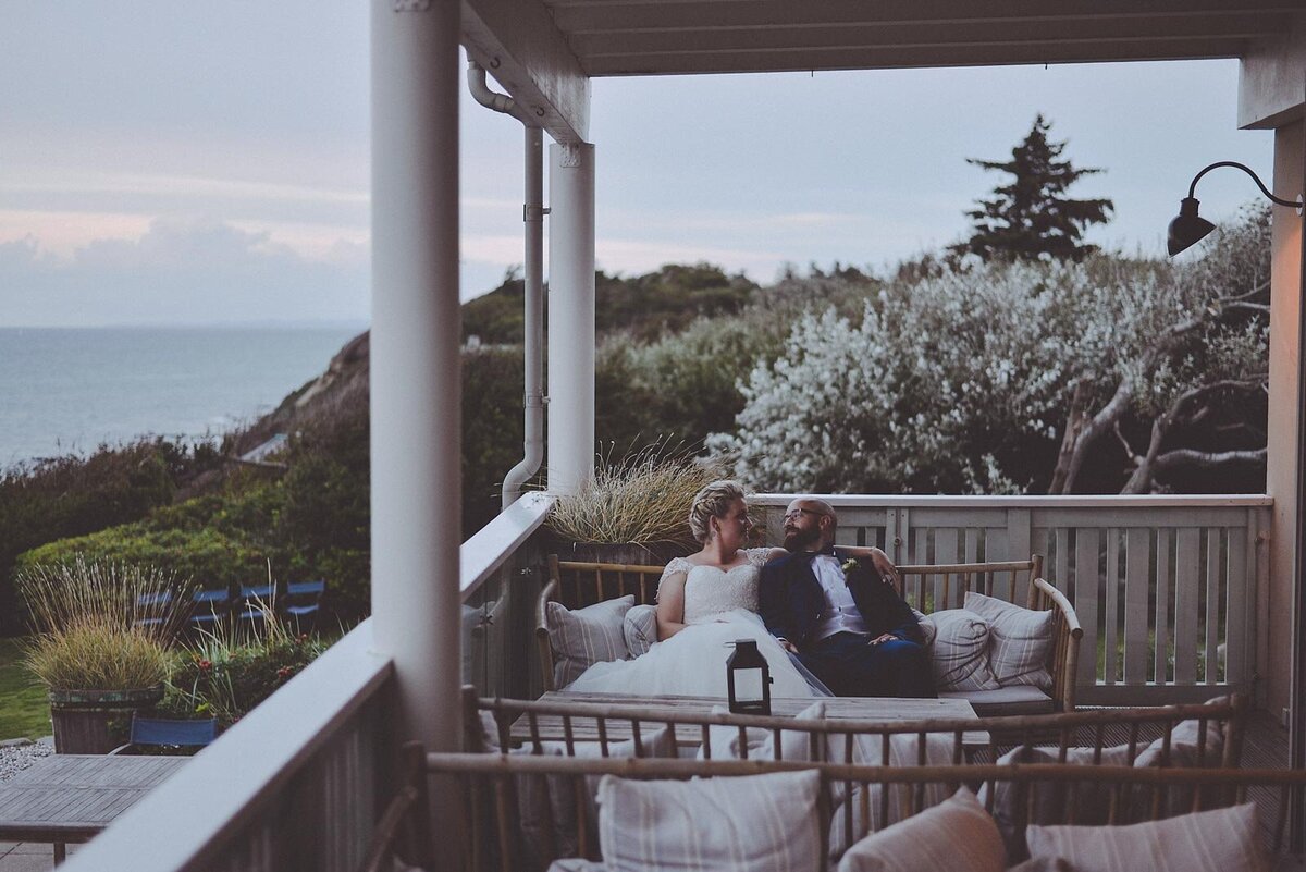 couple sitting on porch at their destination wedding