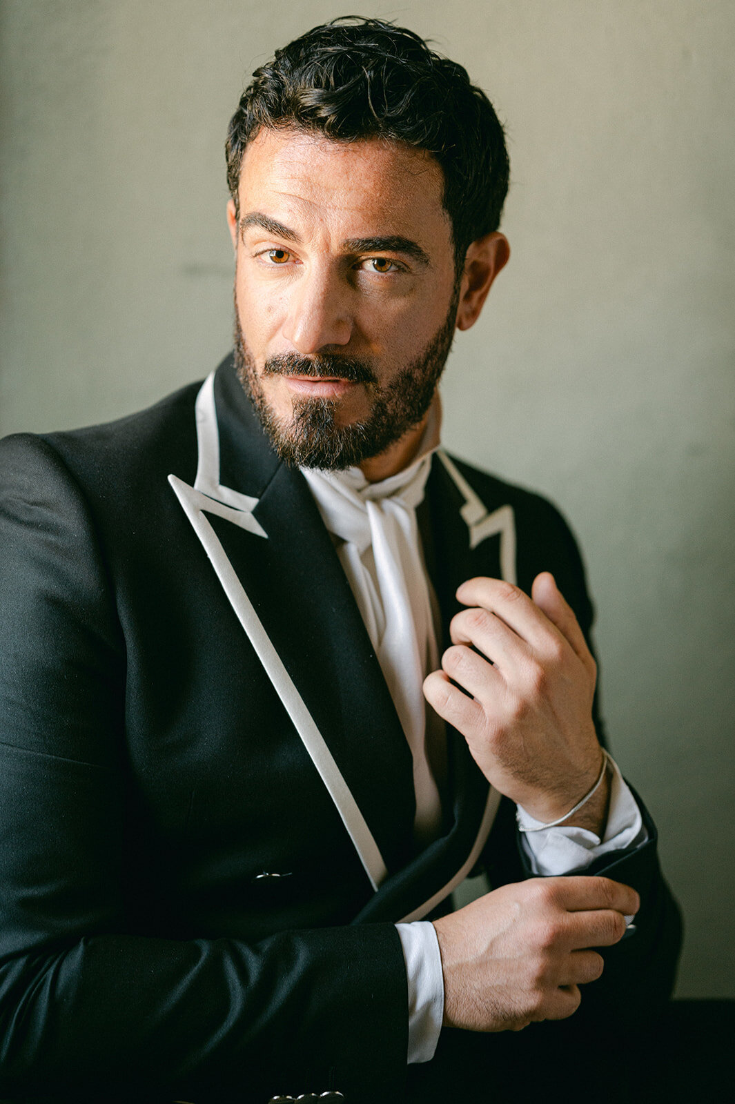 Groom adjusts his cuff link during his Italian Wedding.