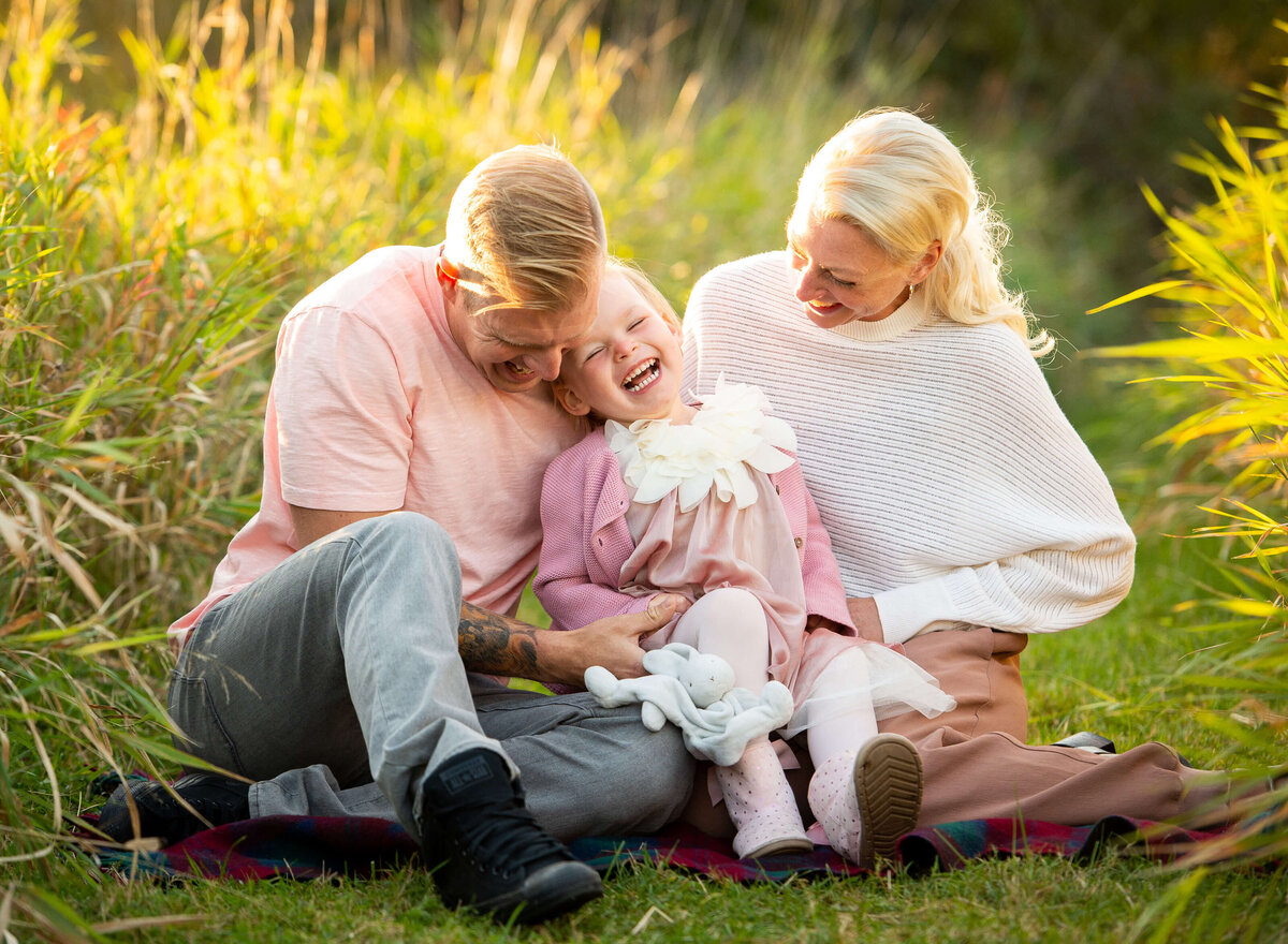 mom and dad tickling their toddler during their Ottawa Family Photography