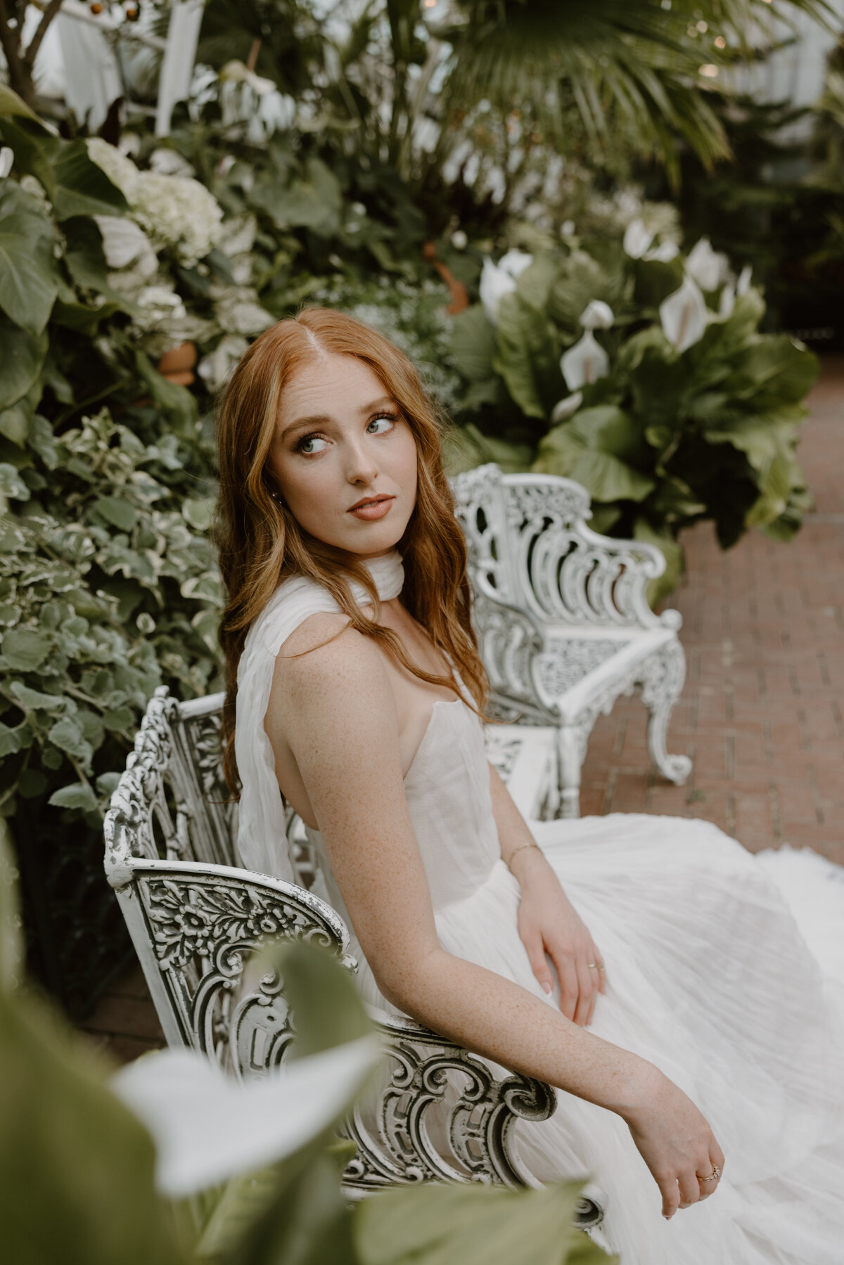 Bride exuding effortless elegance in a minimalist Watters gown inside the Biltmore conservatory.