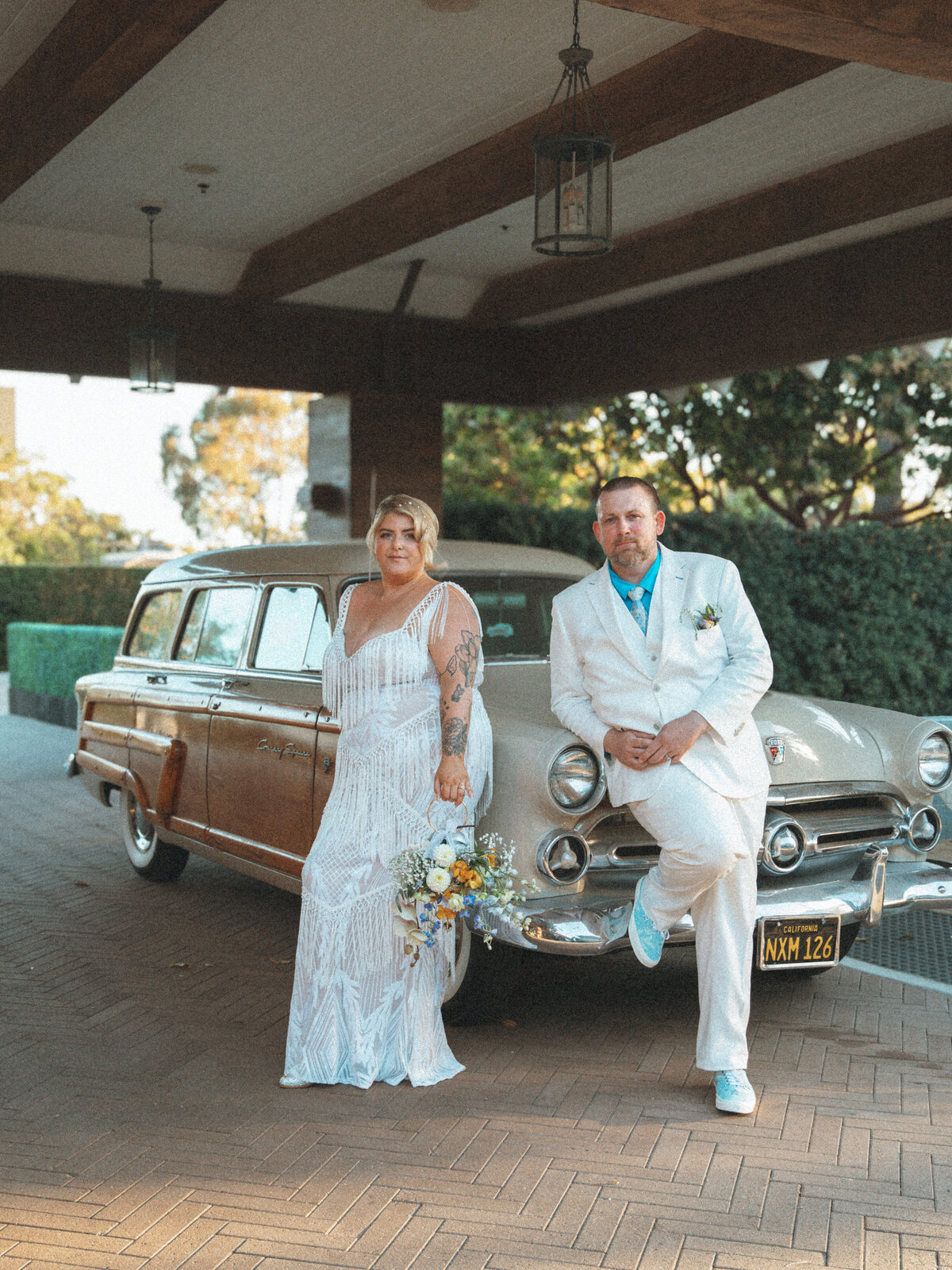 bride and groom with vintage car