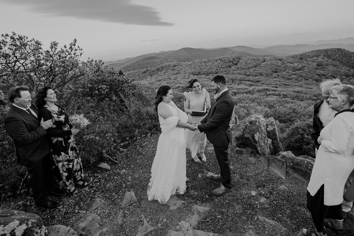 A bride is looks super excited, as the officiant is about to officially proclaim them husband and wife. 